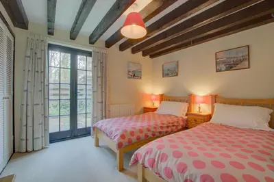 a bedroom with two beds and a large window at 2 Bed in Padstow oc-p00002 in Padstow