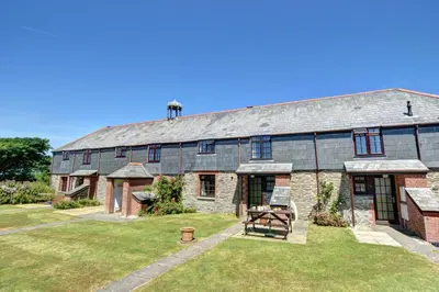 a large brick building with a picnic table in the yard at 2 Bed in Padstow oc-p00002 in Padstow