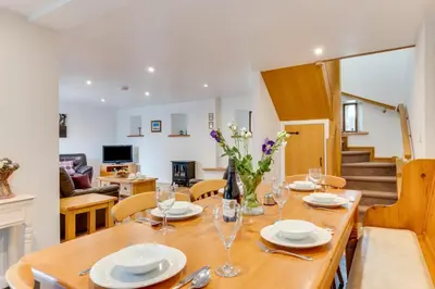 a dining room with a wooden table and chairs at 1 Bed in St. Merryn oc-nel42 in St Merryn