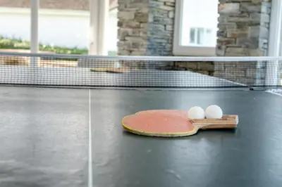two eggs on a tennis racket on a tennis court at 6 Bed in Padstow oc-p00006 in St Merryn