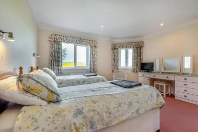 a bedroom with two beds and a television in it at 6 Bed in Padstow oc-p00006 in St Merryn