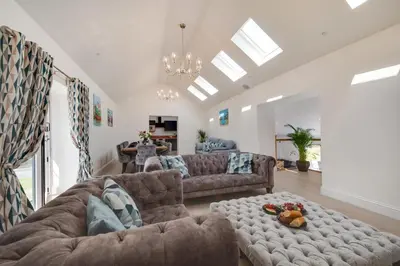 a living room with two couches and a table at 4 Bed in Horningtops oc-northt in Menheniot