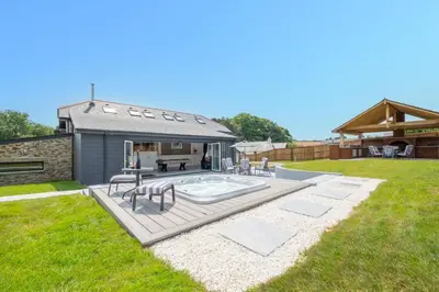 a backyard with a swimming pool and a house at 4 Bed in Horningtops oc-northt in Menheniot