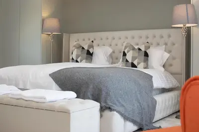a bedroom with a large white bed with a gray blanket at 4 Bed in Horningtops oc-northt in Menheniot