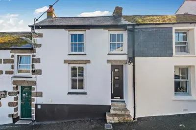 a white house with a black door at 2 Bed in Porthleven oc-nights in Porthleven