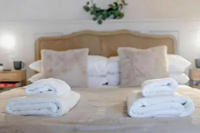 a bed with two towels on top of it at 2 Bed in Porthleven oc-nights in Porthleven