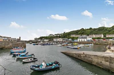 a group of boats are docked in a harbor at 2 Bed in Porthleven oc-nights in Porthleven