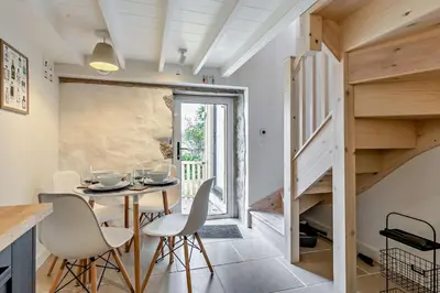 a small dining room with a table and white chairs at 2 Bed in Porthleven oc-nights in Porthleven