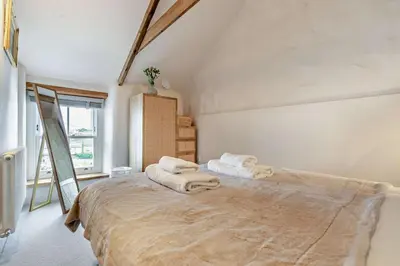 a bedroom with a large bed with towels on it at 2 Bed in Porthleven oc-nights in Porthleven