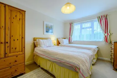a bedroom with two beds and a window at 5 Bed in Padstow oc-p00053 in St Merryn