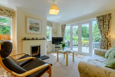 a living room with a couch and a fireplace at 5 Bed in Padstow oc-p00053 in St Merryn
