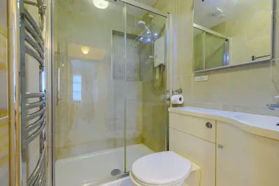a bathroom with a shower and a toilet and a sink at 5 Bed in Padstow oc-p00053 in St Merryn