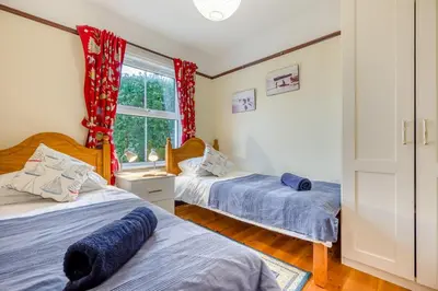 a bedroom with two beds and a window at 3 Bed in Padstow oc-p00043 in St Merryn