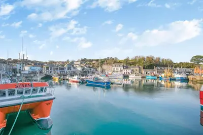 a group of boats are docked in a harbor at 3 Bed in Padstow oc-p00131 in St Merryn