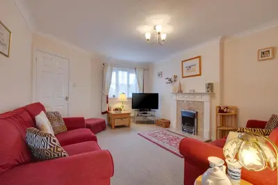 a living room with red couches and a tv at 3 Bed in Wadebridge oc-p00093 in Wadebridge