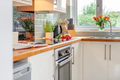 a kitchen with white cabinets and a sink at 3 Bed in St. Merryn oc-p00114 in St Merryn