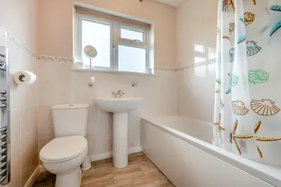 a bathroom with a toilet and a sink and a tub at 3 Bed in St. Merryn oc-p00114 in St Merryn
