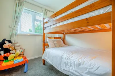 a bedroom with a bunk bed with a ladder at 3 Bed in St. Merryn oc-p00114 in St Merryn