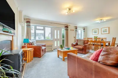a living room with leather furniture and a tv at 3 Bed in St. Merryn oc-p00114 in St Merryn