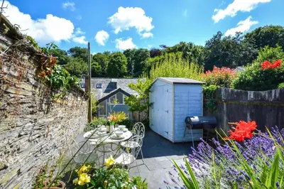 a garden with a table and a shed at 2 Bed in Padstow oc-p00082 in Padstow