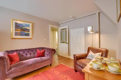 a living room with a couch and a table at 2 Bed in Padstow oc-p00082 in Padstow