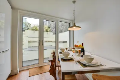 a dining room with a white table and a window at 2 Bed in Padstow oc-p00082 in Padstow