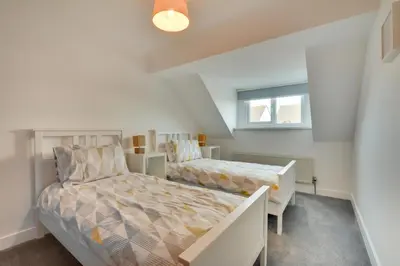 a bedroom with two beds and a window at 4 Bed in Padstow oc-p00184 in Padstow