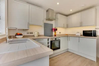 a kitchen with white cabinets and a sink at 4 Bed in Padstow oc-p00184 in Padstow