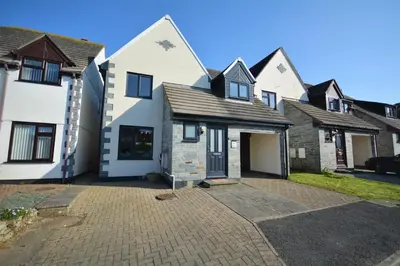 a group of houses with a driveway at 4 Bed in Padstow oc-p00184 in Padstow