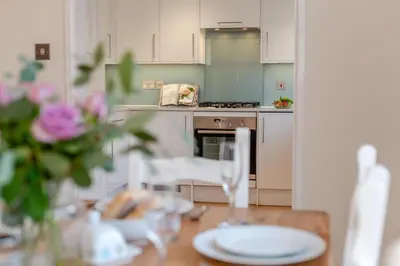 a kitchen with a wooden table with a table sidx sidx sidx at 3 Bed in Padstow oc-p00175 in Padstow