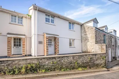 a white house with a stone wall at 3 Bed in Padstow oc-p00175 in Padstow