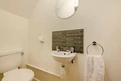a bathroom with a sink and a toilet and a mirror at 3 Bed in Padstow oc-p00175 in Padstow
