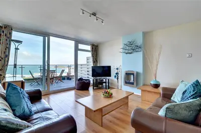 a living room with a couch and a table and a television at 2 Bed in Newquay oc-p00214 in Newquay