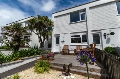 a house with a wooden deck in front of it at 2 Bed in Newquay oc-p00214 in Newquay