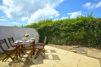 a table and chairs sitting on a patio at 2 Bed in Padstow oc-p00183 in Padstow