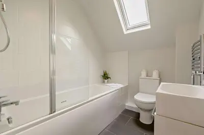 a white bathroom with a toilet and a sink at 2 Bed in Padstow oc-p00183 in Padstow