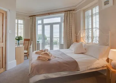 a bedroom with a bed with a large window at 2 Bed in Padstow oc-p00134 in Padstow