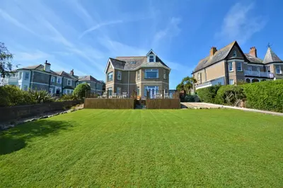 a large lawn in front of a large house at 2 Bed in Padstow oc-p00134 in Padstow