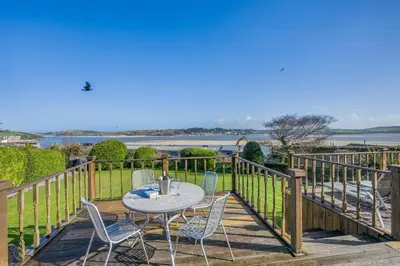 a patio with a table and chairs on a wooden deck at 2 Bed in Padstow oc-p00134 in Padstow