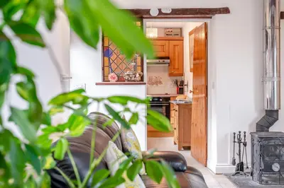 a living room with a couch and a stove at 2 Bed in Padstow oc-p00249 in Padstow