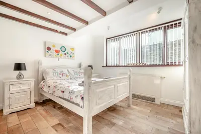 a bedroom with a white bed and a window at 2 Bed in Padstow oc-p00249 in Padstow