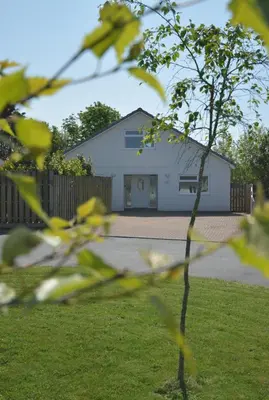 a white house with a tree in a yard at 3 Bed in St. Merryn oc-p00251 in St Merryn