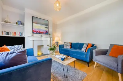a living room with two blue couches and a fireplace at 3 Bed in Padstow oc-p00144 in Padstow