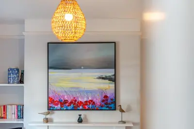 a painting on a wall with a chandelier at 3 Bed in Padstow oc-p00144 in Padstow