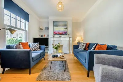 a living room with two blue couches and a table at 3 Bed in Padstow oc-p00144 in Padstow