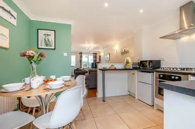 a kitchen and living room with a table and chairs at 2 Bed in Padstow oc-p00254 in Padstow