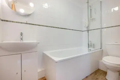 a white bathroom with a sink and a toilet at 2 Bed in Padstow oc-p00254 in Padstow