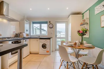 a kitchen with a table and chairs and a sink at 2 Bed in Padstow oc-p00254 in Padstow