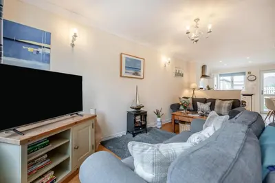 a living room with two couches and a flat screen tv at 2 Bed in Padstow oc-p00254 in Padstow