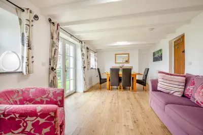 a living room with a purple couch and a table at 3 Bed in Padstow oc-p00294 in Saint Issey